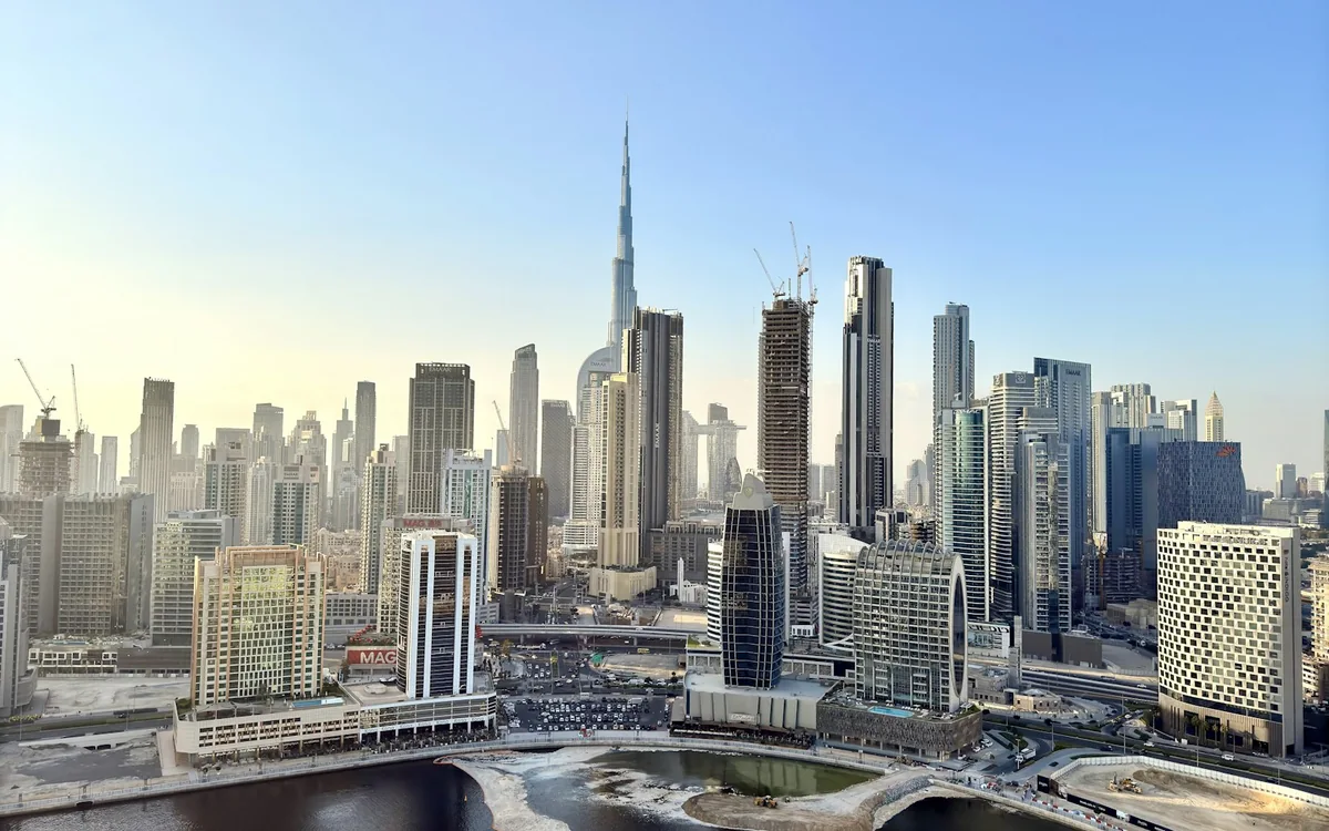 Dubai skyline with the Burj Khalifa, surrounding buildings and Business Bay waterfront.